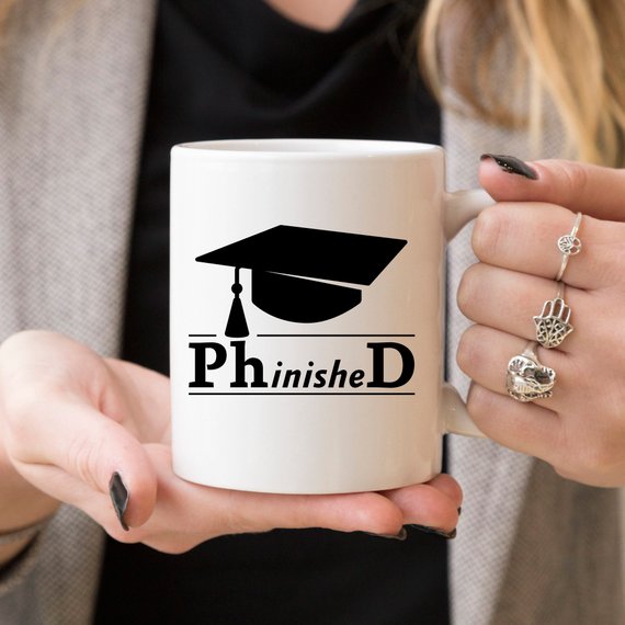 PhinisheD 11oz Coffee Mug featuring a humorous design, perfect for coffee lovers and graduates.